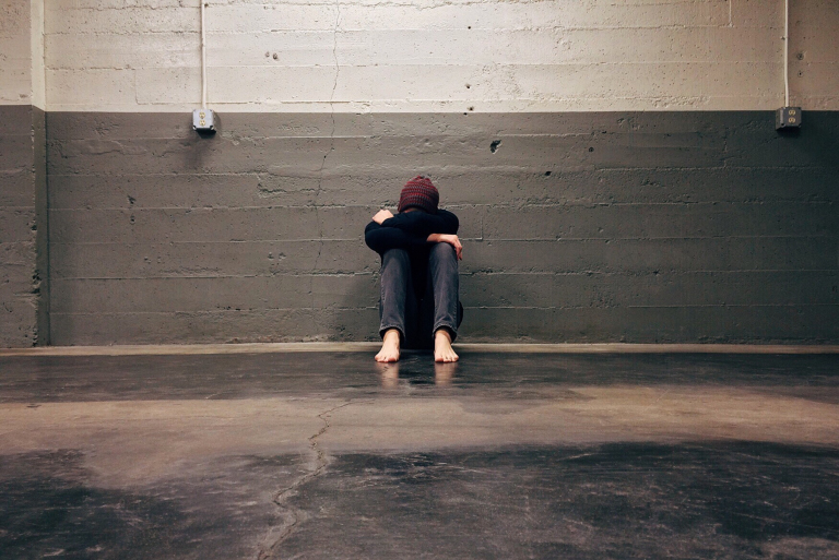 Man talking to his therapist over a video call about managing panic attacks