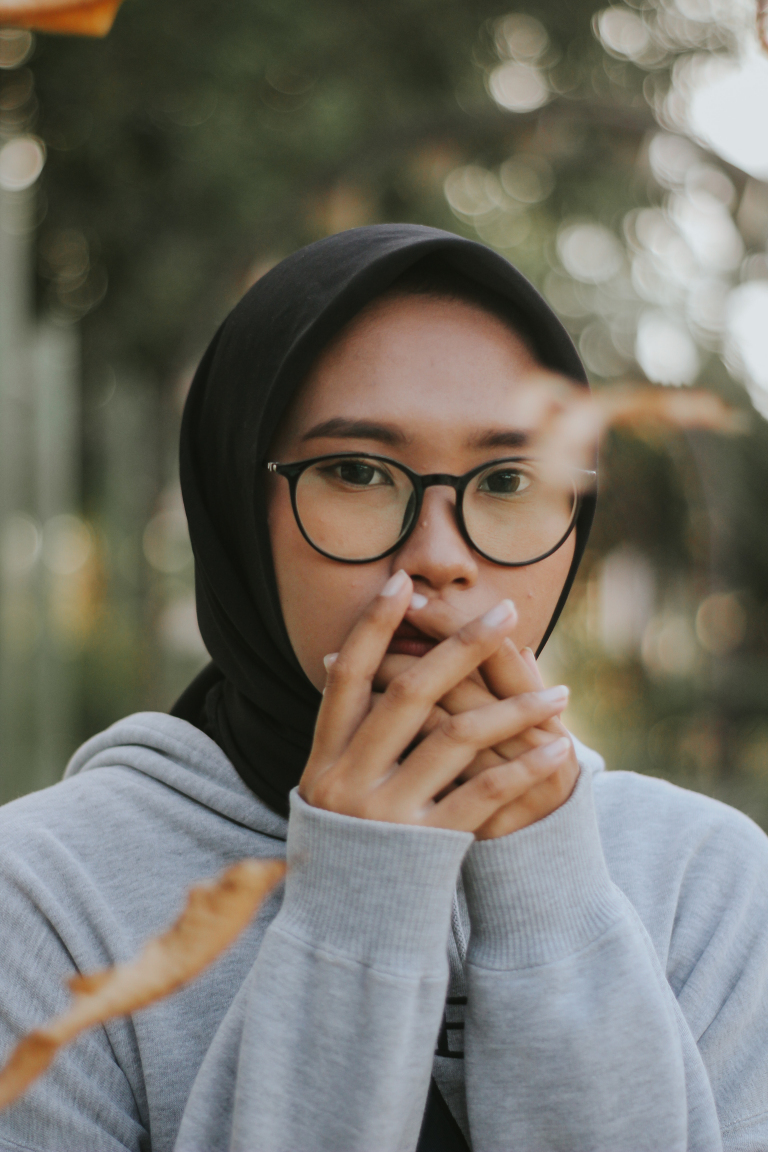Woman holding her chest during a panic attack at home, before online panic disorder counselling