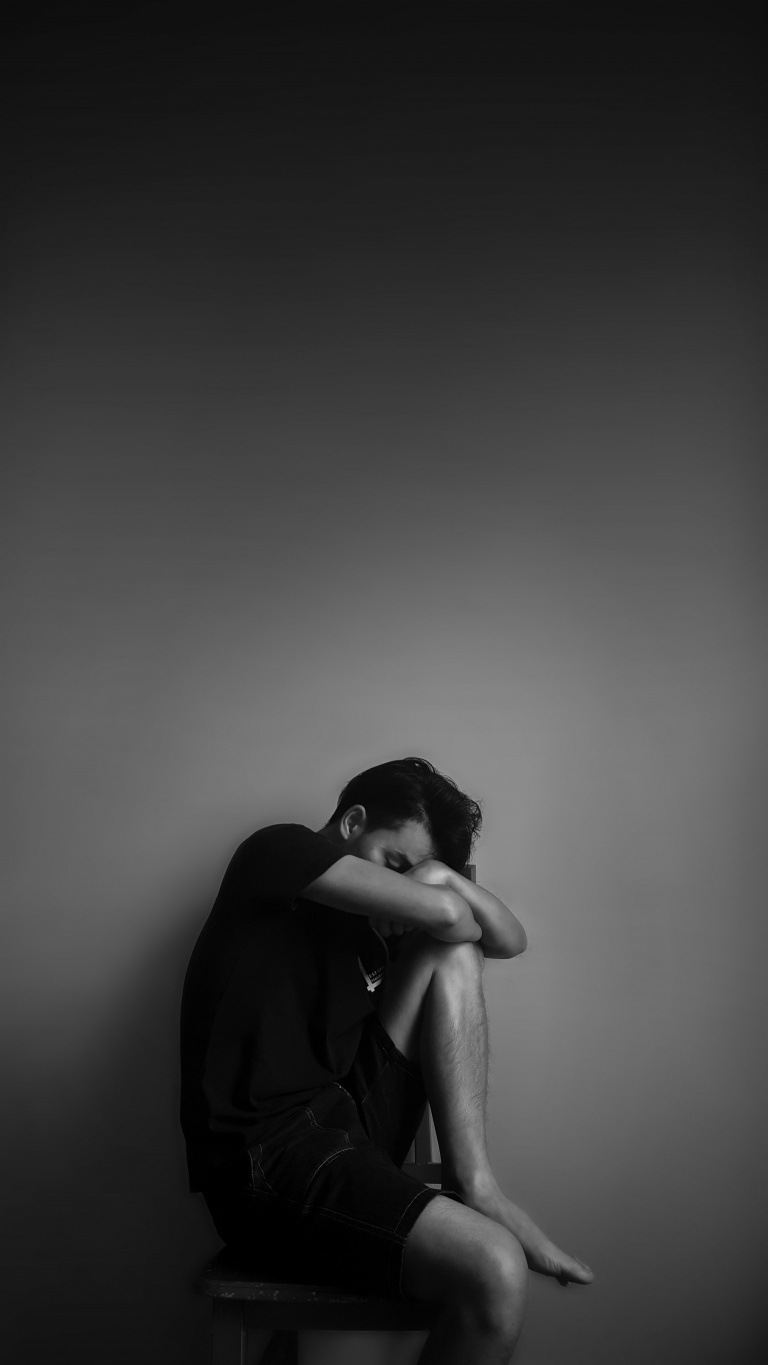 Person talking gently with their therapist over a video call