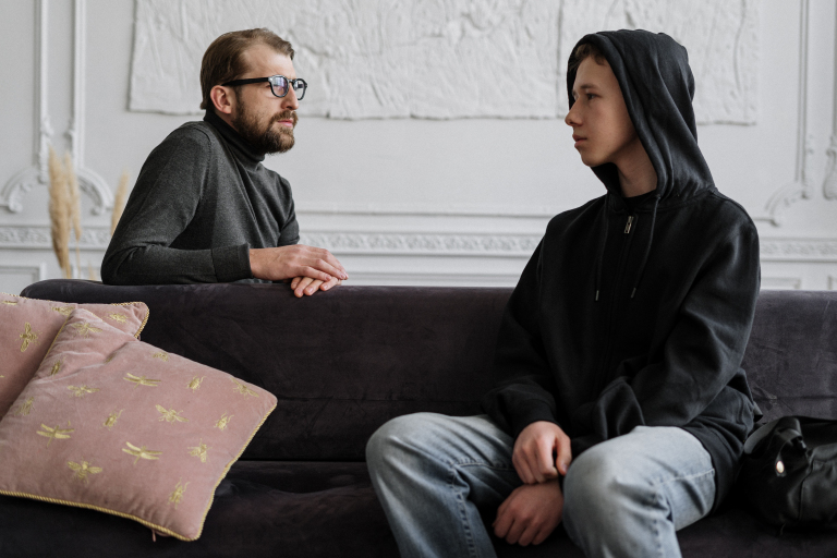 Young girl chatting with a friendly therapist over a video call