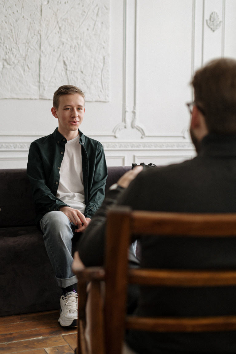 Man talking to his therapist about attachment and relationships over a video call