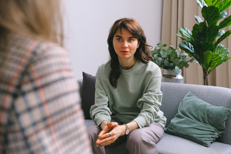 Woman exploring her communication patterns with a therapist over a video call